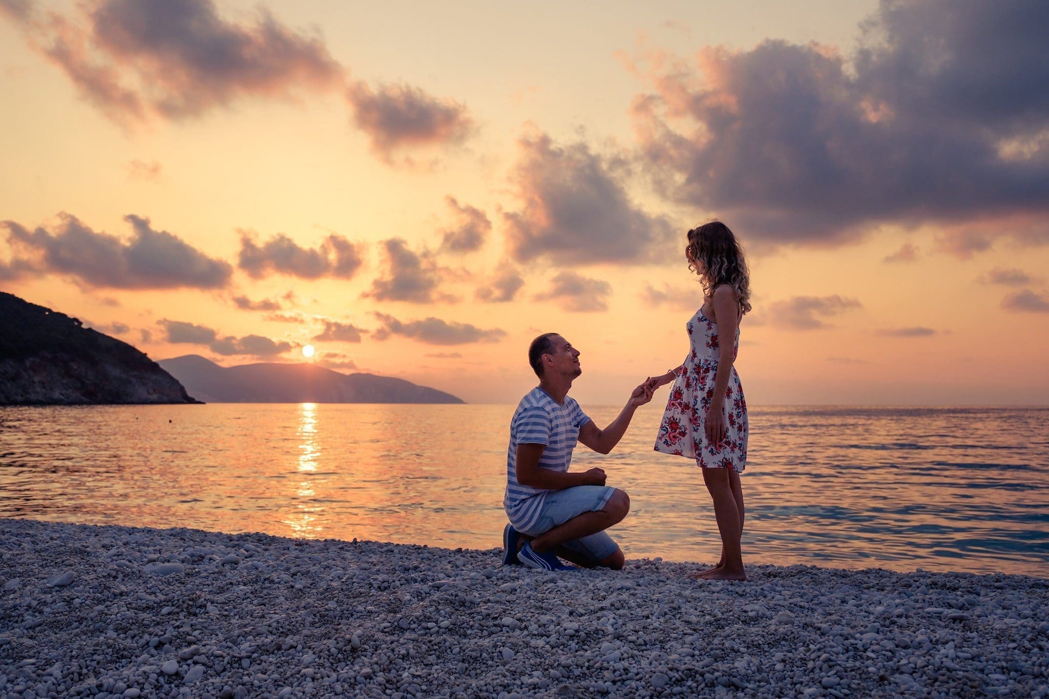 Romantic marriage proposal on a beach. What knee to put on the ground?